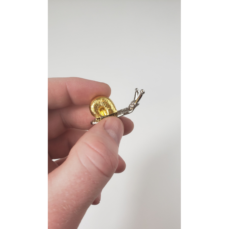 Rgelsesholder snegl, guld og slv farvet